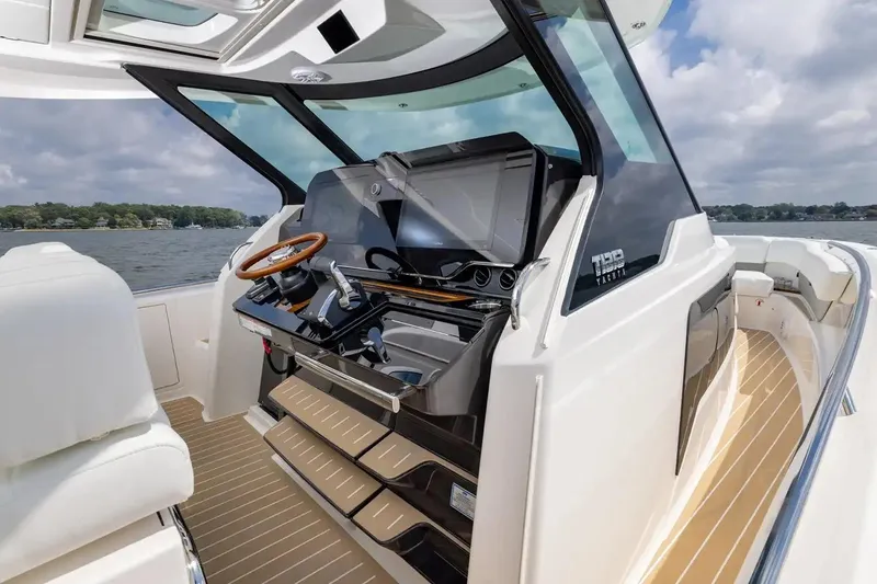 Slide: The Image of Manufacturer Provided Image: 2026 Tiara Yachts 39 LS helm with modern controls and luxurious seating on open water. - 8