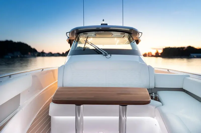 Slide: The Image of Manufacturer Provided Image: 2026 Tiara Yachts 39 LS boat interior with sunset view, featuring sleek design and wooden table. - 7