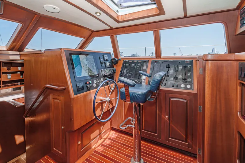 Slide: The Image of Philbrook's 69' Custom PH Sailing Sloop 1999 helm station with navigation controls and captain's chair. - 32