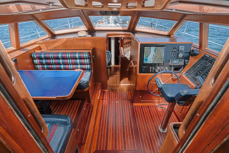 Slide: The Image of Interior of 1999 Philbrook's 69' Custom PH Sailing Sloop with navigation station and dining area. - 30
