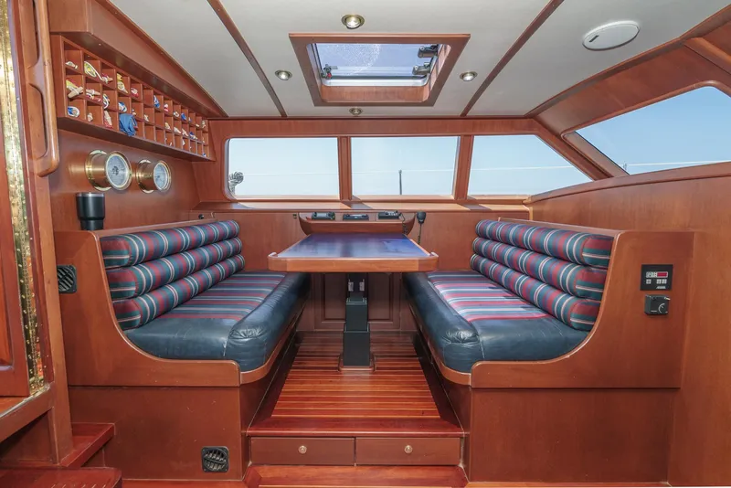 Slide: The Image of Philbrook's 69' Custom PH Sailing Sloop 1999 interior with dining area and striped seating. - 34