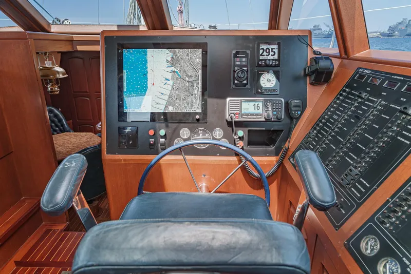 Slide: The Image of Philbrook's 69' Custom PH Sailing Sloop 1999 cockpit with navigation equipment and steering wheel. - 33
