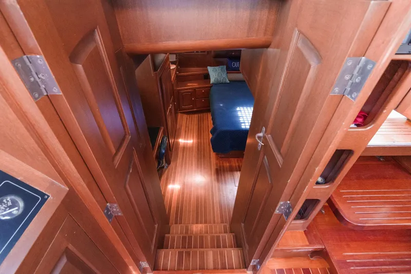 Slide: The Image of Interior of 1999 Philbrook's 69' Custom PH Sailing Sloop with wooden flooring and cozy cabin. - 44
