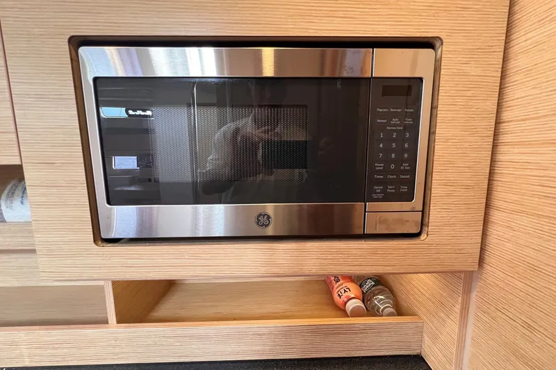 Slide: The Image of Built-in GE microwave in a 2020 Hanse 458 yacht kitchen. - 53