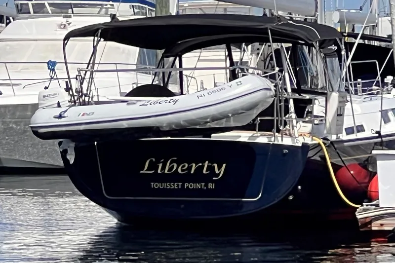 Slide: The Image of 2020 Hanse 458 yacht "Liberty" docked at Touisset Point, RI with dinghy attached. - 2