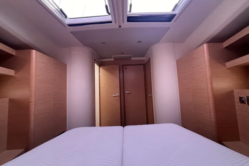 Slide: The Image of Interior cabin of 2020 Hanse 458 yacht with modern wood finish and skylight. - 64