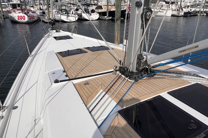 Slide: The Image of 2020 Hanse 458 sailboat deck with rigging, docked in a marina. - 13