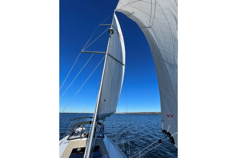 Slide: The Image of Sailing on a 2020 Hanse 458 yacht with full sails under a clear blue sky. - 75