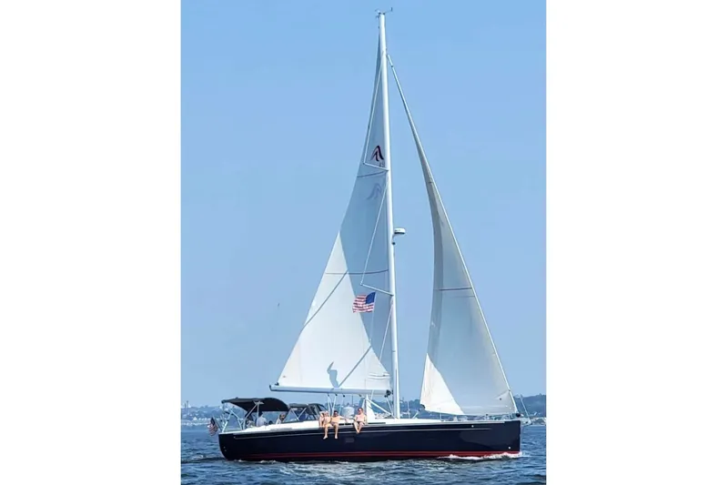 Slide: The Image of 2020 Hanse 458 sailboat cruising on open water under clear blue skies. - 4