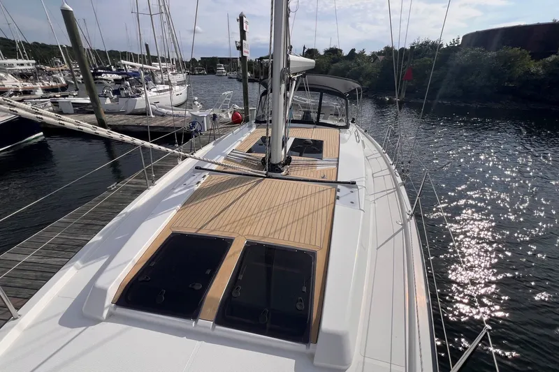 Slide: The Image of 2020 Hanse 458 yacht docked at marina, showcasing sleek deck design and modern features. - 12
