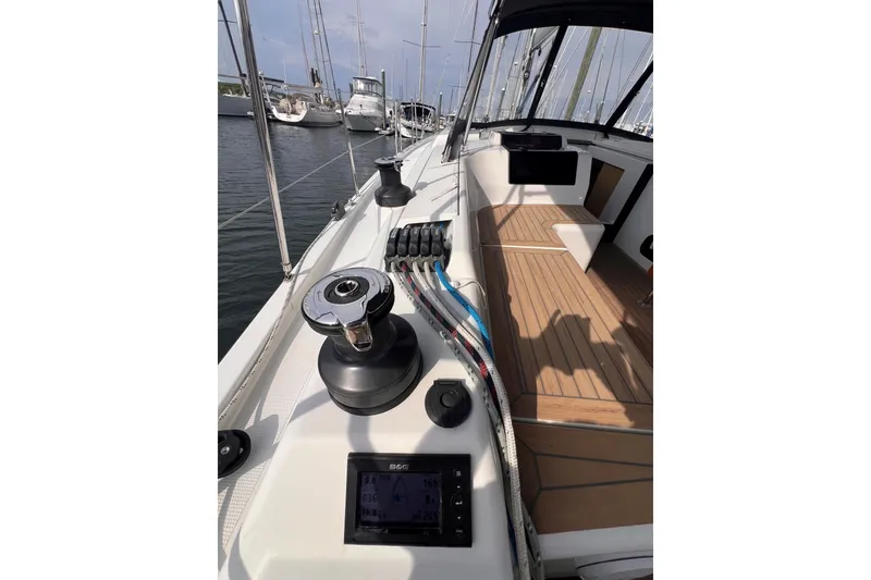 Slide: The Image of 2020 Hanse 458 yacht cockpit with winch, ropes, and navigation display. - 24