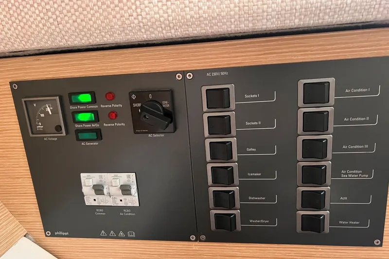 Slide: The Image of Electrical control panel on a 2020 Hanse 458 yacht, featuring switches and voltage indicators. - 59