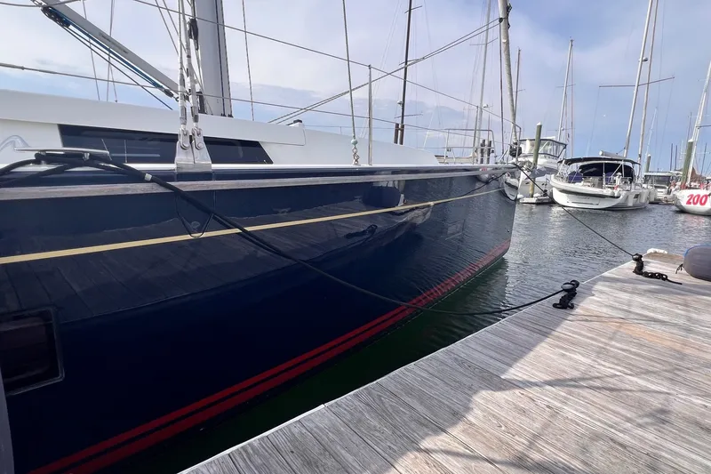 Slide: The Image of 2020 Hanse 458 sailboat docked at marina, sleek design, blue hull, calm waters. - 6
