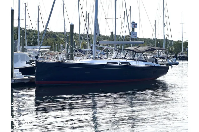 Slide: The Image of 2020 Hanse 458 sailboat docked in a marina, surrounded by other boats. - 3