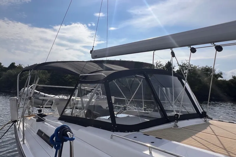 Slide: The Image of 2020 Hanse 458 sailboat with canopy, docked on a sunny day. - 18