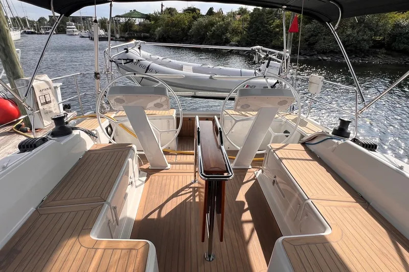 Slide: The Image of 2020 Hanse 458 yacht cockpit with dual steering wheels and wooden deck. - 22