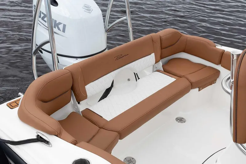 Slide: The Image of Manufacturer Provided Image: 2025 Pioneer 202 Islander boat interior with brown and white seating, Suzuki engine visible. - 7