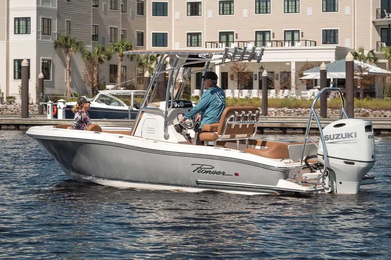 Slide: The Image of Manufacturer Provided Image: 2025 Pioneer 202 Islander boat on water near a waterfront building. - 1