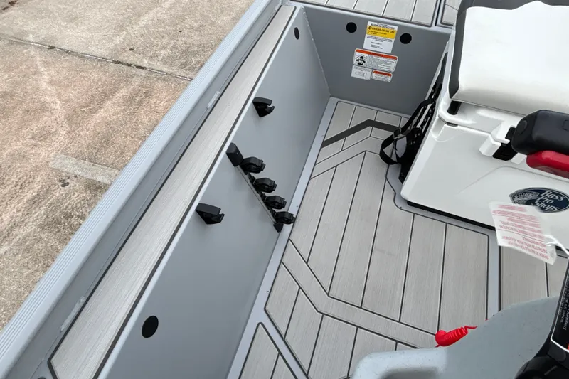 Slide: The Image of 2027 Tracker Bass Tracker Classic CC boat interior with rod holders and seating. - 19