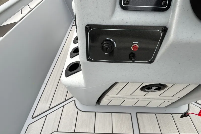 Slide: The Image of 2027 Tracker Bass Tracker Classic CC boat console with controls and cup holders. - 14