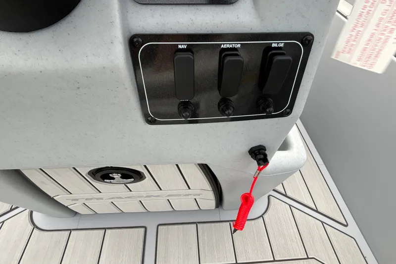 Slide: The Image of Control panel of 2027 Tracker Bass Tracker Classic CC boat with switches and safety cord. - 15