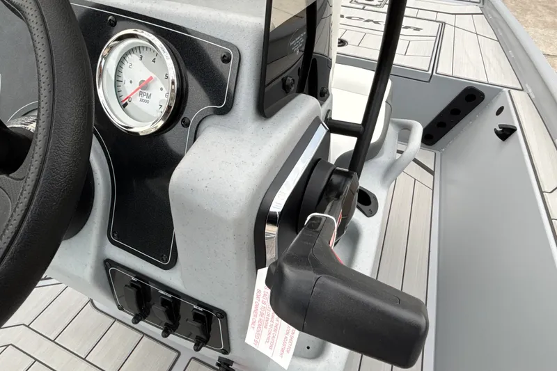 Slide: The Image of 2027 Tracker Bass Tracker Classic CC dashboard with RPM gauge and controls. - 16