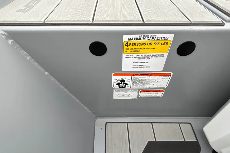 Slide: The Image of 2027 Tracker Bass Tracker Classic CC capacity label, maximum 4 persons or 566 lbs. - 24