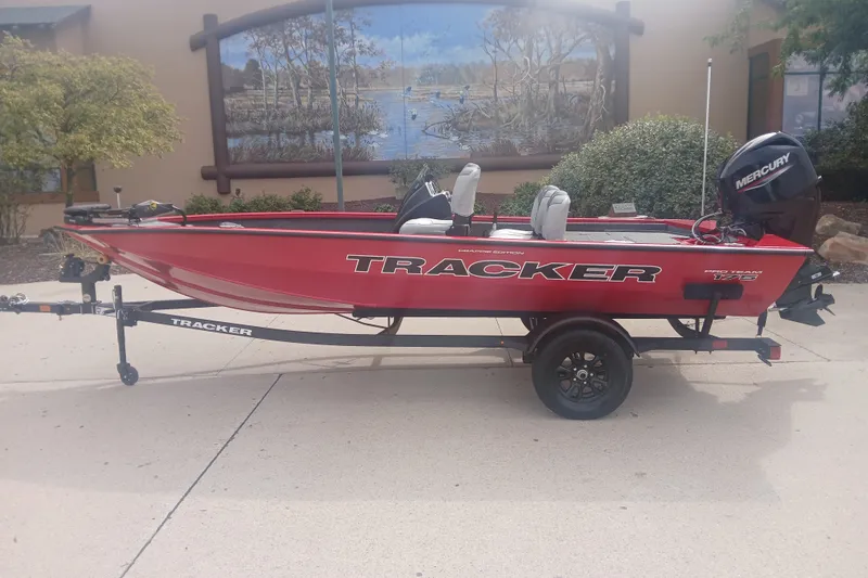 The Image of Red 2027 Tracker Pro Team 175 Crappie Edition boat on trailer, outdoor setting. - 0