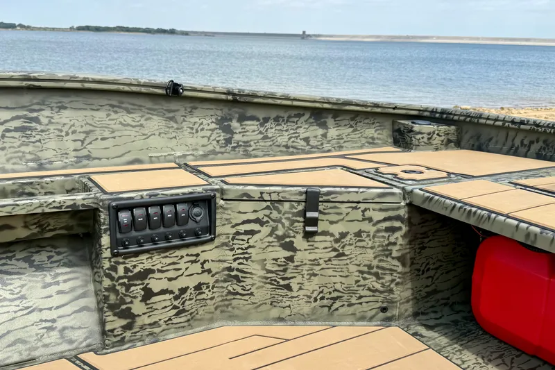 Slide: The Image of 2027 Tracker Grizzly 1553 Timber boat interior with camouflage design by the water. - 15