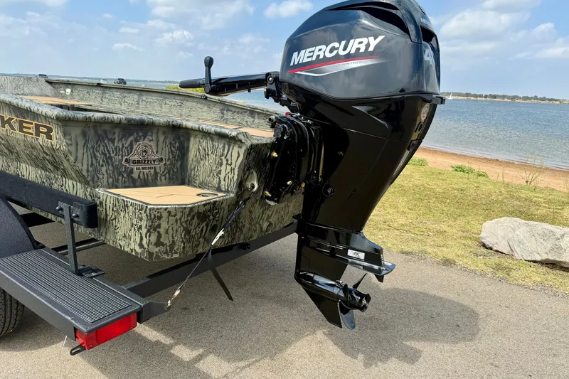 Slide: The Image of 2027 Tracker Grizzly 1553 Timber boat with Mercury outboard motor by a lake. - 13