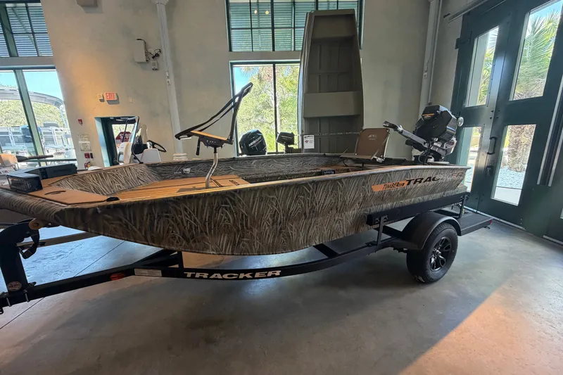 The Image of 2027 Tracker Grizzly 1553 Timber boat displayed indoors on a trailer. - 0