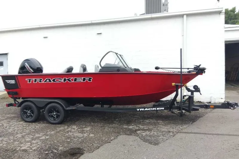 The Image of 2027 Tracker Targa V-19 WT boat in vibrant red on a trailer, parked outdoors. - 0
