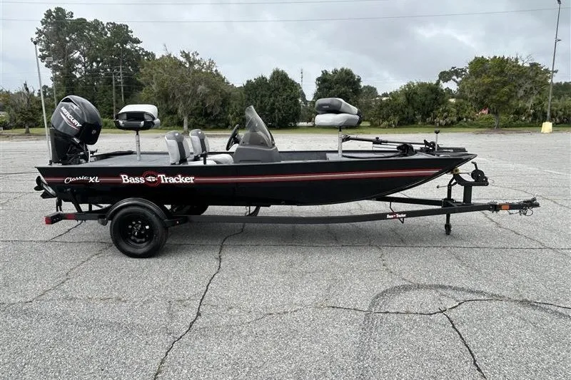 The Image of 2027 Tracker Bass Tracker Classic XL fishing boat on trailer in parking lot. - 0