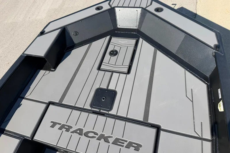 Slide: The Image of 2027 Tracker Grizzly 1756 T Marsh boat deck with sleek gray design and storage compartments. - 20
