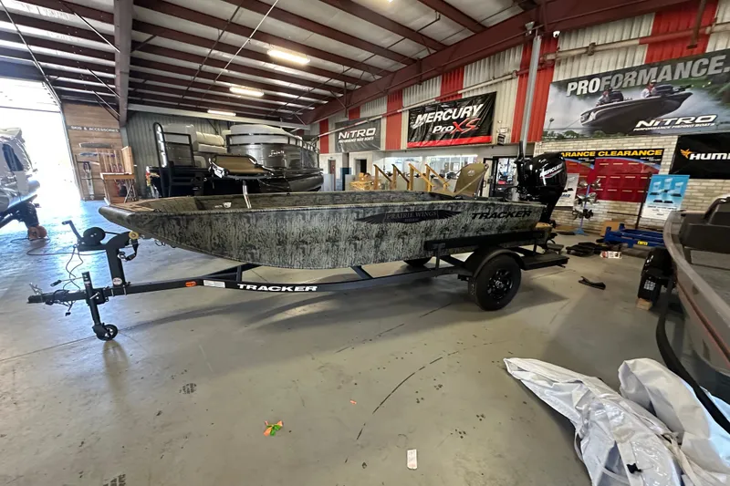The Image of 2027 Tracker Grizzly 1650 T Prairie Wings Edition boat in showroom, side view. - 0
