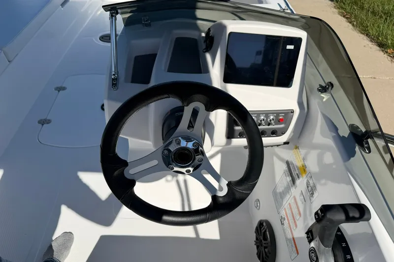 Slide: The Image of Steering console of a 2027 Tahoe T18 boat with modern controls and display. - 14