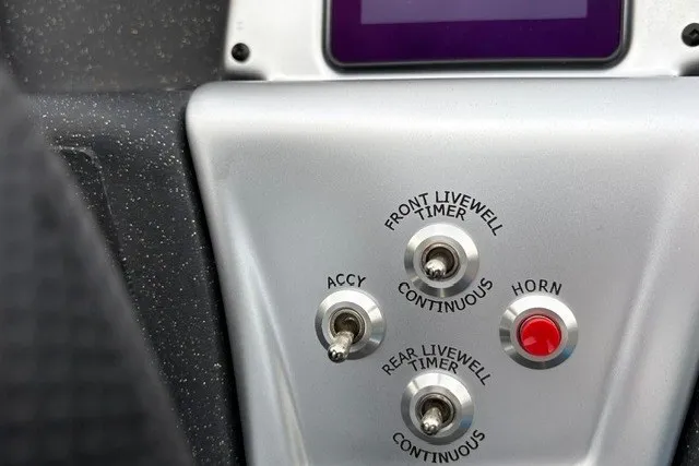 Slide: The Image of Control panel of 2027 Tracker Pro Team 175 Crappie Edition boat with switches and buttons. - 26
