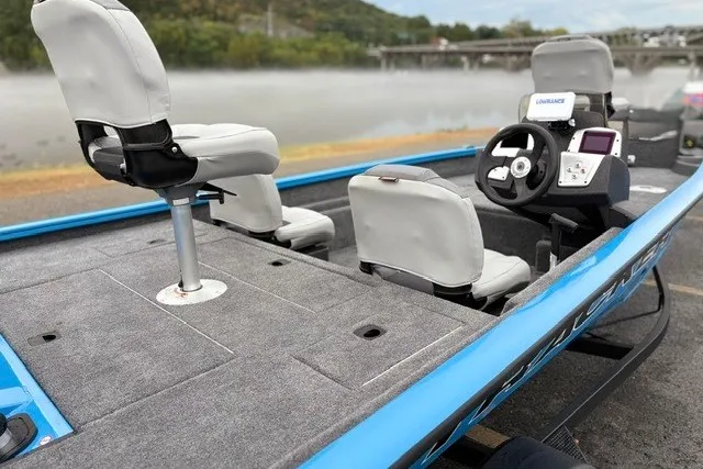 Slide: The Image of 2027 Tracker Pro Team 175 Crappie Edition boat with seating and steering console, docked by a misty river. - 20