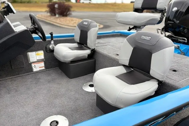 Slide: The Image of 2027 Tracker Pro Team 175 Crappie Edition boat interior with gray seating and steering console. - 30