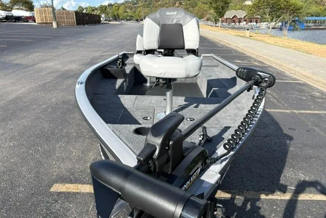Slide: The Image of 2027 Tracker Super Guide V-16 T fishing boat with trolling motor in a parking lot. - 13