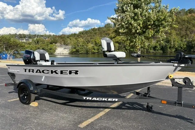 Slide: The Image of 2027 Tracker Super Guide V-16 T boat on trailer by a scenic lake. - 16
