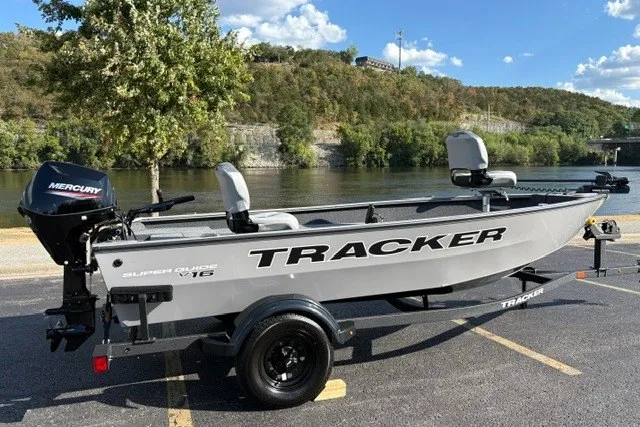 Slide: The Image of 2027 Tracker Super Guide V-16 T fishing boat on trailer by a scenic river. - 15