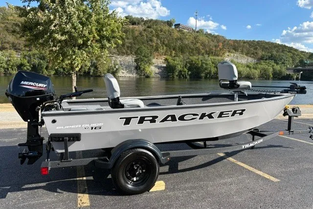 The Image of 2027 Tracker Super Guide V-16 T boat with Mercury motor, parked by a scenic river. - 22