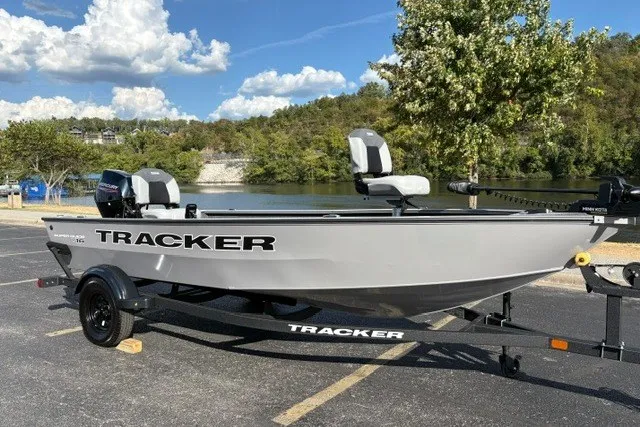 Slide: The Image of 2027 Tracker Super Guide V-16 T boat on trailer by a scenic lake. - 17