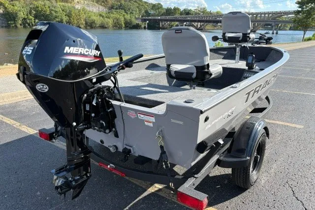 Slide: The Image of 2027 Tracker Super Guide V-16 T fishing boat with Mercury 25 engine, parked by a scenic river. - 28