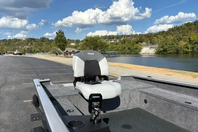 Slide: The Image of Tracker Super Guide V-16 T boat, 2027 model, parked near a scenic lake under a blue sky. - 25