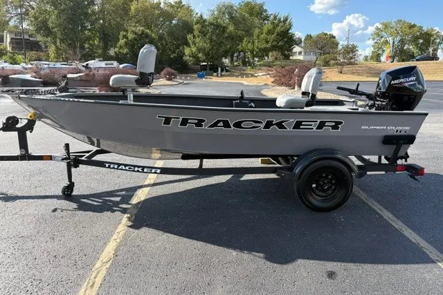 Slide: The Image of 2027 Tracker Super Guide V-16 T fishing boat on trailer, parked outdoors. - 21