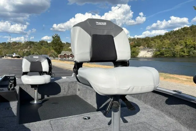 Slide: The Image of 2027 Tracker Super Guide V-16 T boat seats, featuring comfortable design by a scenic lake. - 18