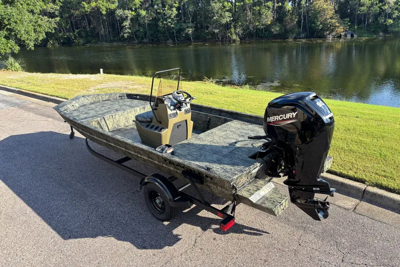 Slide: The Image of 2027 Tracker Grizzly 1860 CC boat with Mercury engine by a scenic lake. - 64