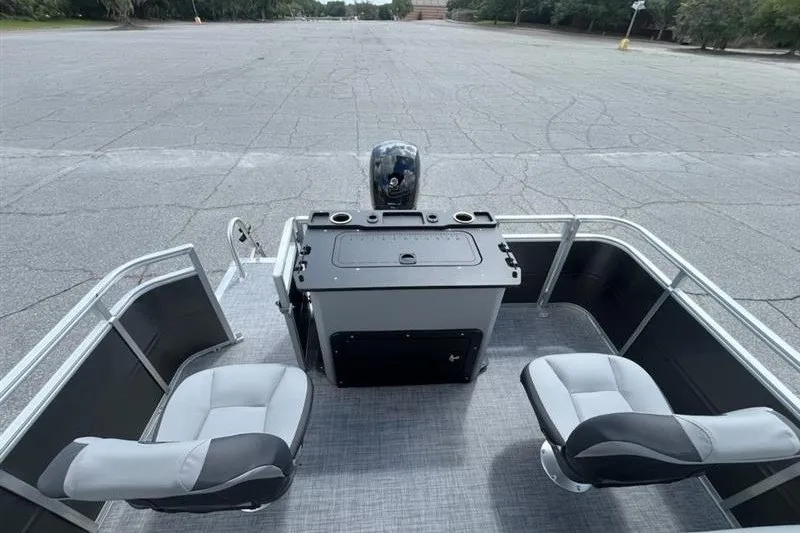 Slide: The Image of 2027 Sun Tracker SportFish 22 DLX pontoon boat interior with seating and control console. - 14